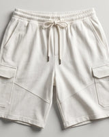 Off-white cargo shorts with an elastic drawstring waistband, laid flat on a light gray background.
