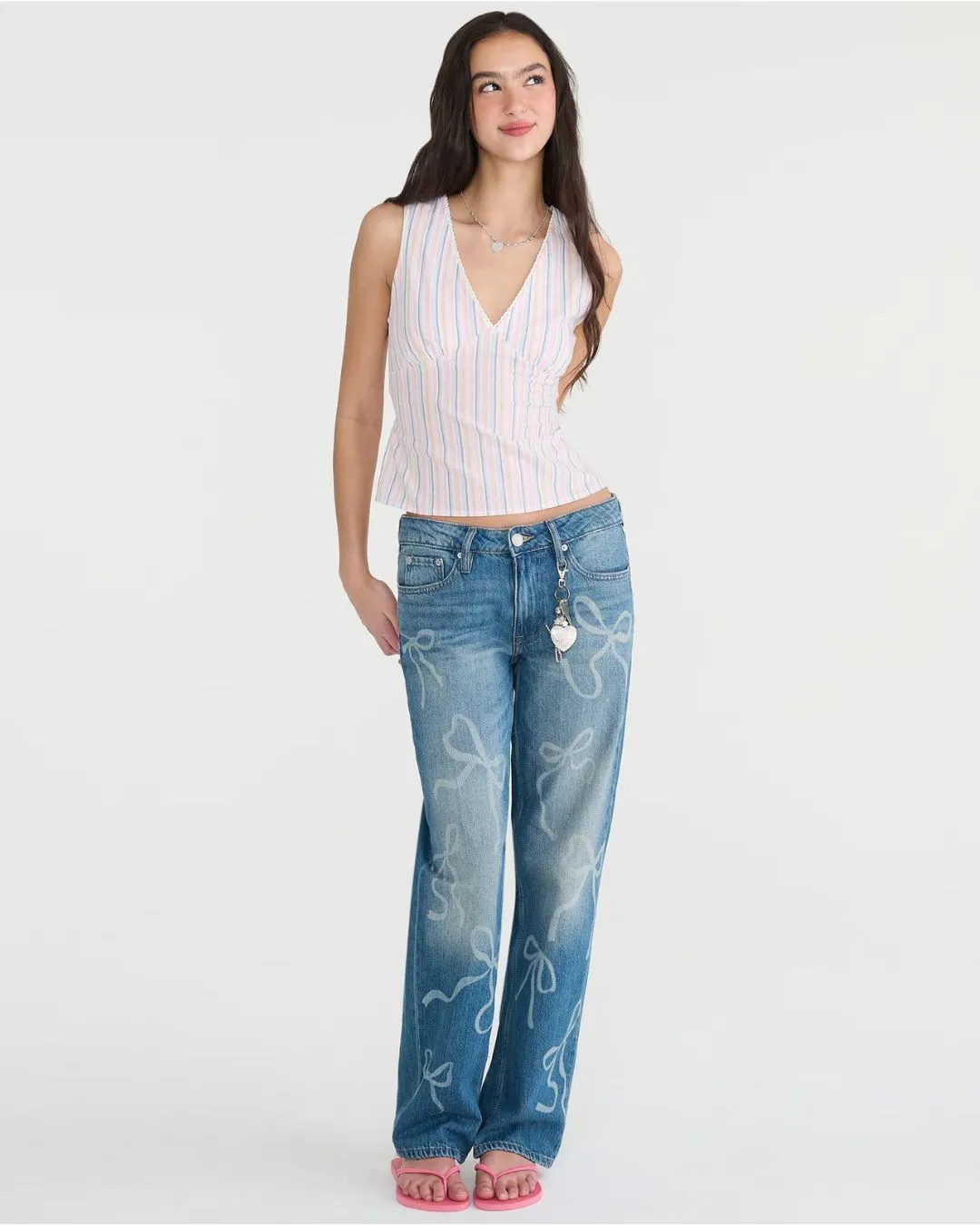 Low rise baggy fit jeans in dark wash with playful bow prints and relaxed comfort for everyday style.