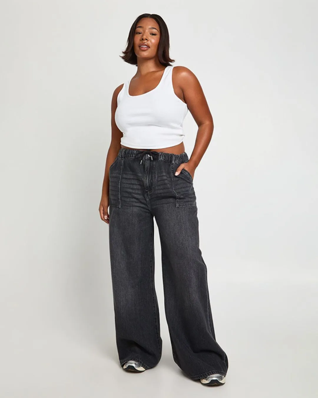 Black washed wide leg denim joggers with elastic waist and adjustable drawstring for relaxed comfort and effortless everyday style.