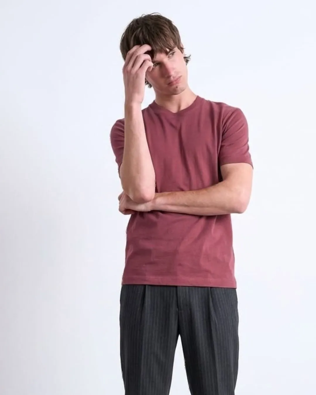 Modern mens burgundy red tee with clean crew neck style and soft comfort. Easy everyday wear that pairs with trousers or denim for relaxed confident fashion.