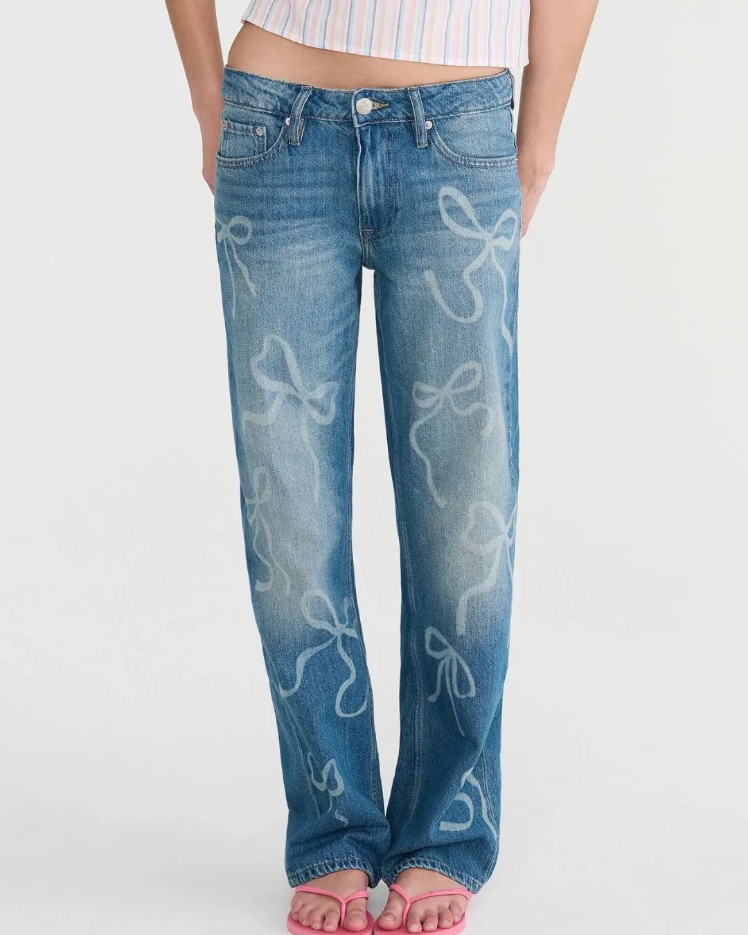 Low rise baggy fit jeans in dark wash with playful bow prints and relaxed comfort for everyday style.
