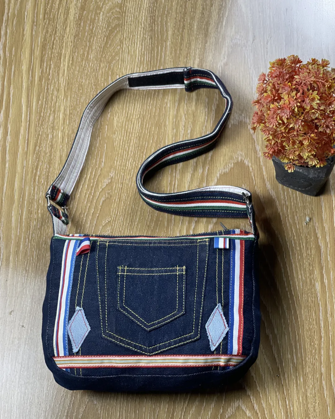 A bold denim crossbody crafted from reclaimed jeans designed for everyday style and conscious fashion lovers.